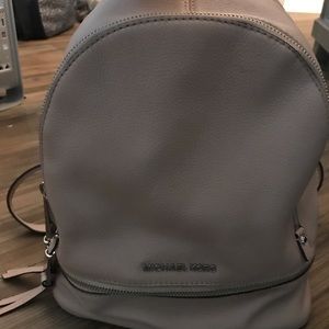 Michael Kors pale pink backpack purse.